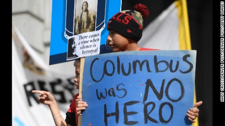 Young demonstrators protest a Columbus Day parade in Denver on Saturday. 