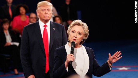 ST LOUIS, MO - OCTOBER 09:  Democratic presidential nominee former Secretary of State Hillary Clinton (R) speaks as Republican presidential nominee Donald Trump looks on during the town hall debate at Washington University on October 9, 2016 in St Louis, Missouri. This is the second of three presidential debates scheduled prior to the November 8th election.  (Photo by Rick Wilking-Pool/Getty Images)