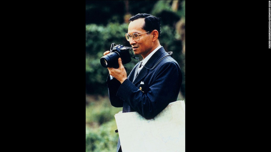 The King raises a camera to take a photo in 1995. He was given his first camera in 1934, which ignited a lifelong enthusiasm for photography. He has often been seen with a camera around his neck during public appearances.