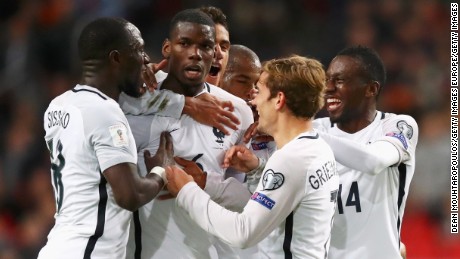 Paul Pogba is mobbed by his teammates after scoring France&#39;s winning goal.