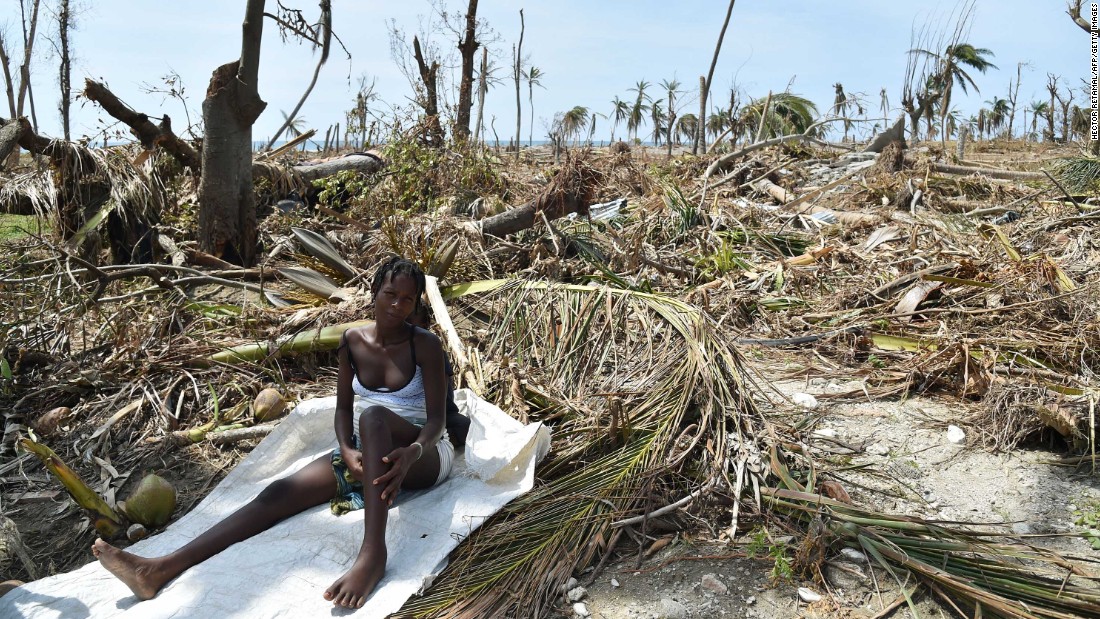 A woman sits in debris where her house once stood in Les Cayes on October 10.