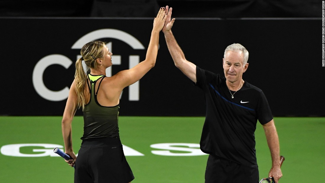 Sharapova celebrates winning a point with partner McEnroe when they teamed up against Roddick and Navratilova. 