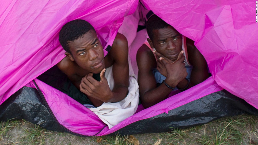 Two young men who lost their homes awake from a tent in the courtyard of a school where they took shelter in Port Salut on October 10.