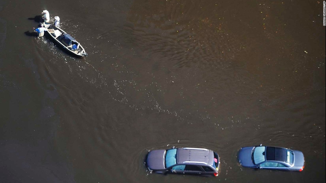 People wade through floodwaters with a boat in Nichols, South Carolina, on Monday, October 10. Hurricane Matthew caused flooding and damage in the Southeast -- from Florida to North Carolina -- after slamming Haiti and other countries in the Caribbean.