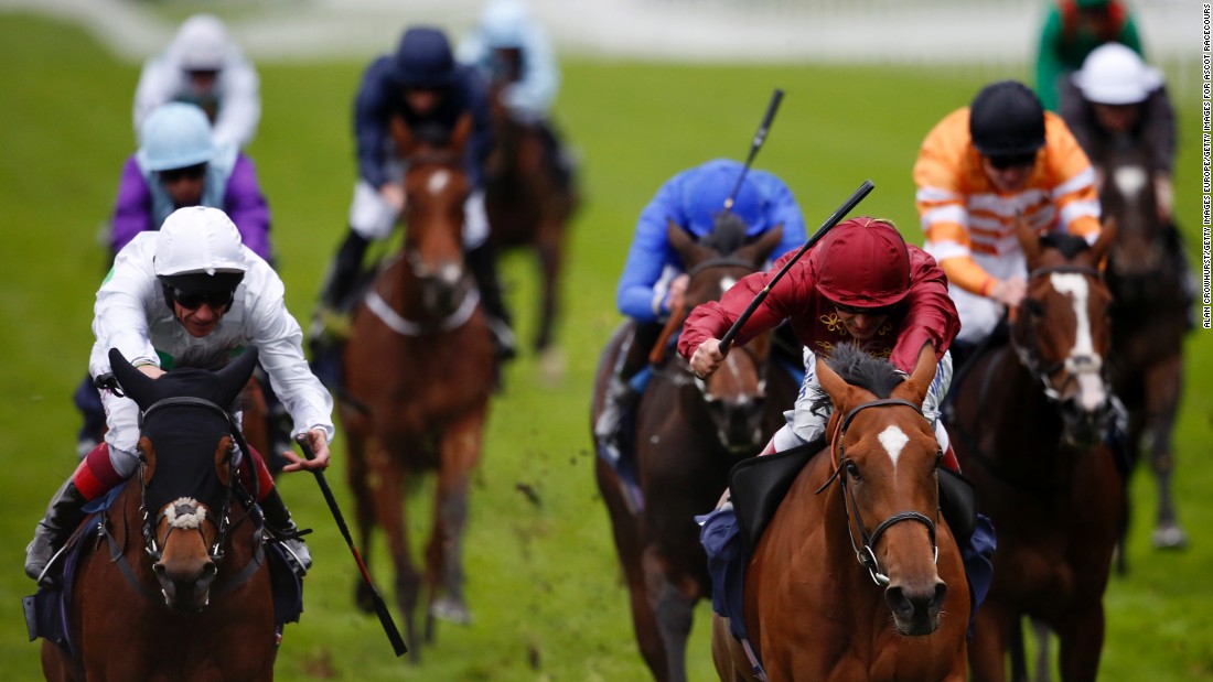 Andrea Atzeni rides Simple Verse (right, maroon colors) to victory in the 2015 British Champions Fillies and Mares Stakes.