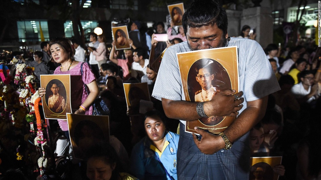 People react to news of the King&#39;s death outside Siriraj Hospital in Bangkok on Thursday.