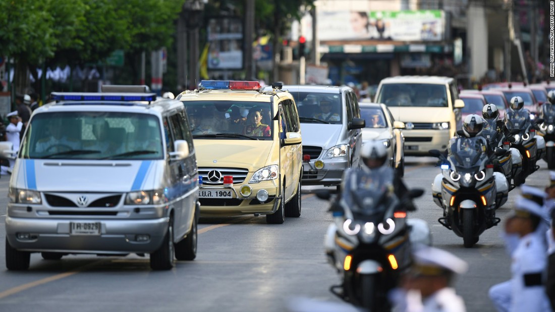 Amid a procession of vehicles, a van carries the body of the King to his palace in Bangkok on Friday.