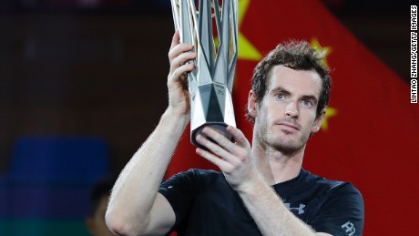 Andy Murray poses with trophy after beating Roberto Bautista Agut of Spain in the final of the Shanghai Masters.
