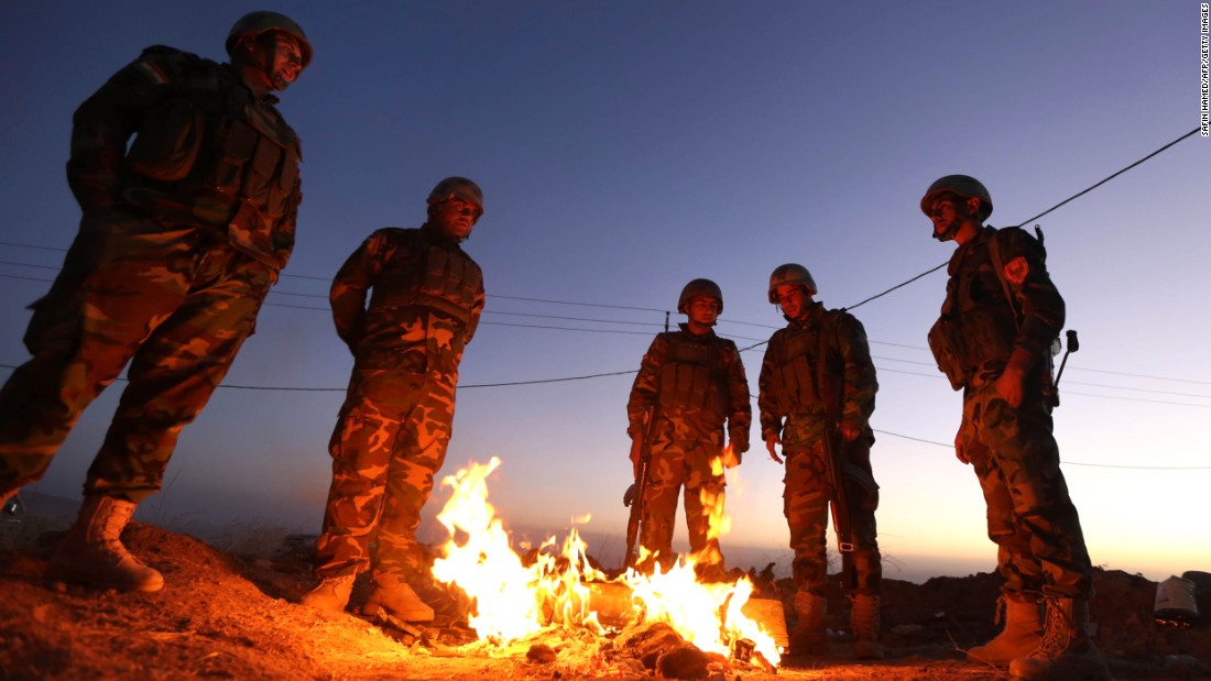 Members of the Iraqi coalition gather around a fire at Zardak mountain ahead of the offensive.