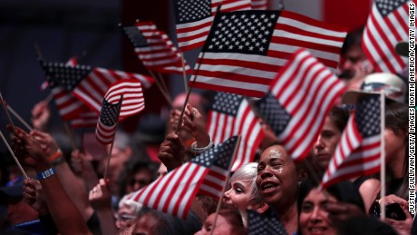 Supporters of democratic presidential candidate former Secretary of State Hillary Clinton wave American flags during a primary night event on June 7, 2016 in Brooklyn, New York. Six states will vote in presidential primaries a day after the Associated Press declared that Hillary Clinton has enough delegates to become the presumptive democratic nominee. 