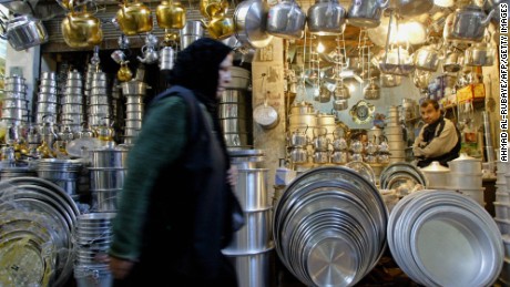  A Muslim Shiite Iraqi woman walks past a shop in Mosul in 2004, long before ISIS took the city. 