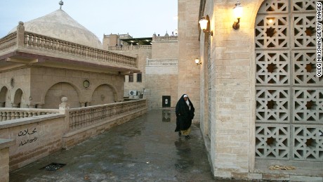 An Iraqi woman walks near the mosque of the Prophet Usuf in October 2002.