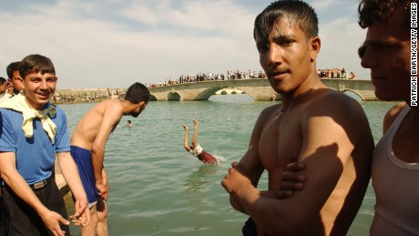 Boys enjoy a swim in 2003, when Mosul residents were free from ISIS rule.