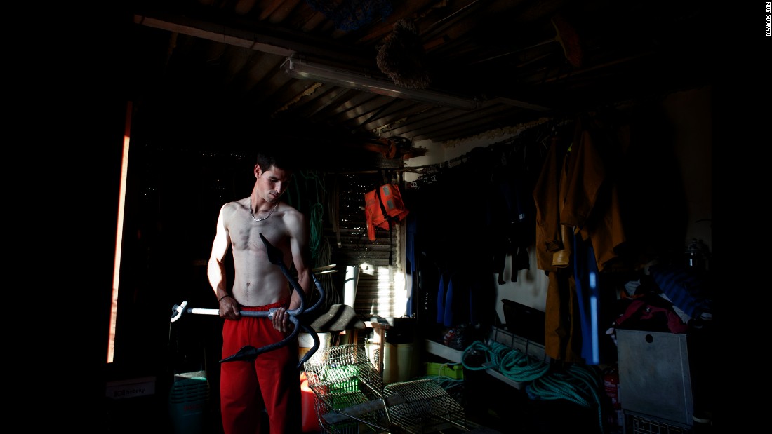 Fran, 26, checks the anchor of his small boat before heading out to sea. He is the youngest percebeiro in his family. He was forced to join the family business when Spain&#39;s real-estate market collapsed.