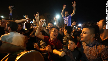 Displaced Christians from Qaraqosh celebrate in Irbil as Iraqi forces move in to free their hometown. 