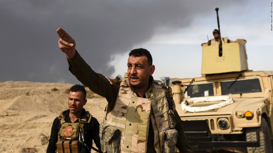 Iraqi forces head toward the front lines near Qayyara on Tuesday, October 18.