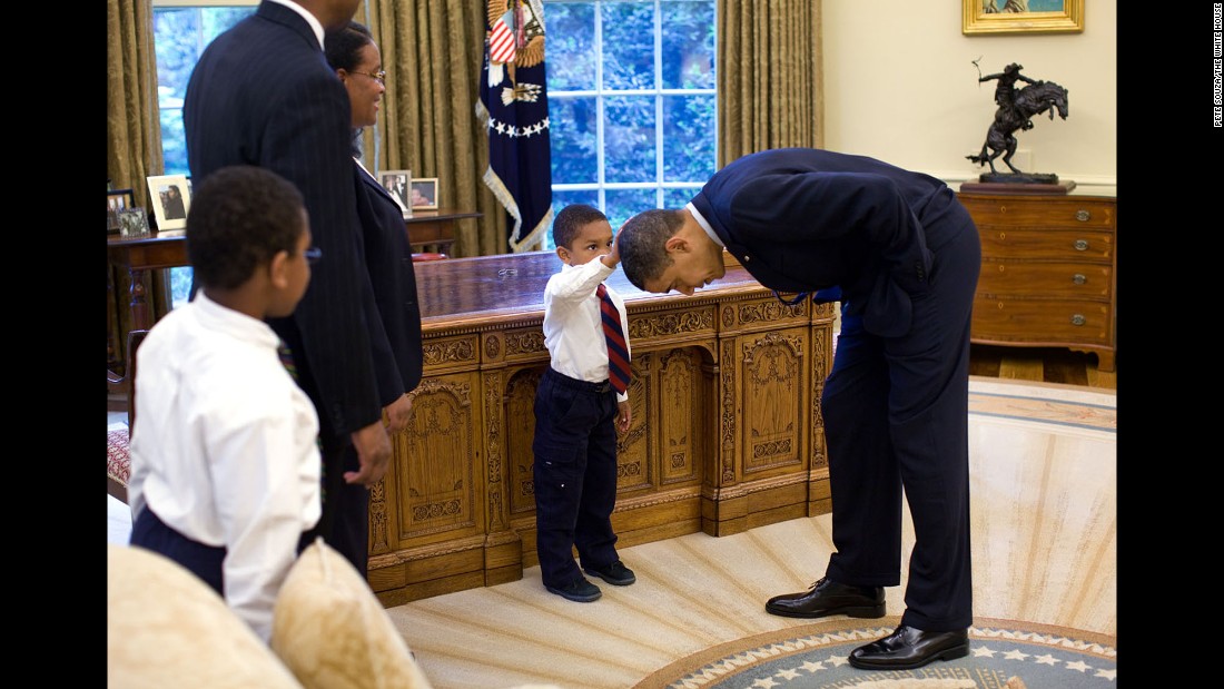 A boy touches Obama&#39;s hair in the Oval Office on May 8, 2009. &quot;A temporary White House staffer, Carlton Philadelphia, brought his family to the Oval Office for a farewell photo with President Obama,&quot; White House photographer Pete Souza said. &quot;Carlton&#39;s son softly told the President he had just gotten a haircut like President Obama, and asked if he could feel the President&#39;s head to see if it felt the same as his.&quot;