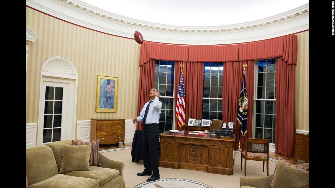 Obama tosses a football in the Oval Office on January 6, 2014.