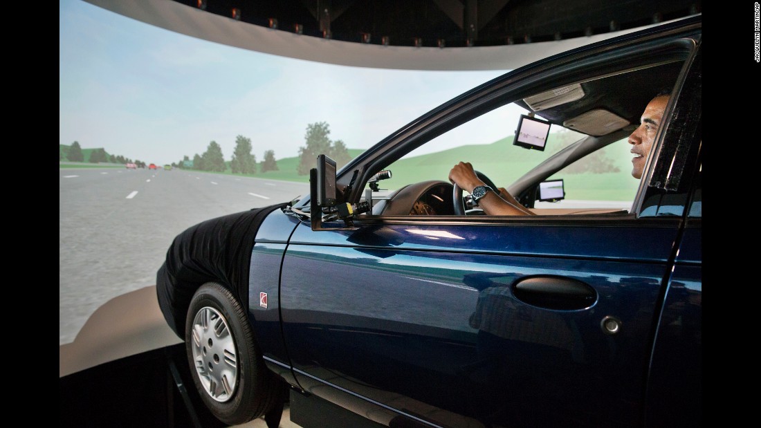 Obama tries out a driving simulator July 15, 2014, as he tours the Turner-Fairbank Highway Research Center in McLean, Virginia. The simulator was meant to demonstrate the types of &quot;smart&quot; vehicles being developed at the center.