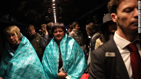 Passengers wore emergency blankets to keep warm outside the terminal.