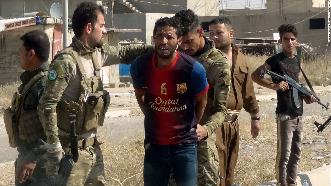 Kurdish security forces detain a suspected member of ISIS in the eastern suburbs of Kirkuk on Saturday, October 22.