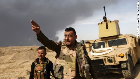 A member of Iraqi forces gestures towards the frontline on October 18, near the town of Qayyara, during an operation to recapture the city of Mosul from ISIS.