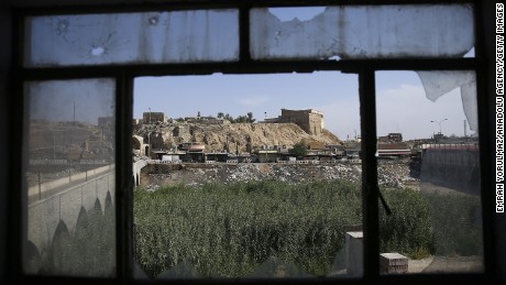 A view of Kirkuk is seen through the broken window of Jihad Hotel on October 22. ISIS used the hotel as a base during an attack in Kirkuk on Friday.