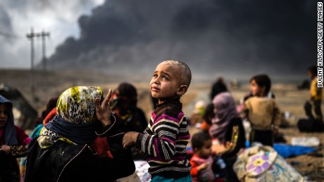 Displaced families gather in an area near Qayyara on October 24.