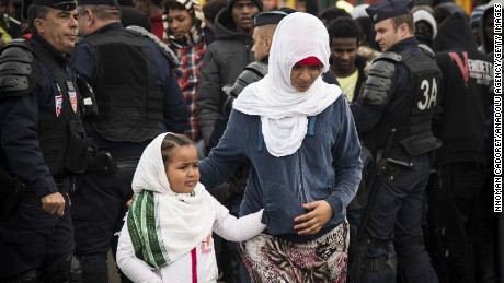 Refugees get ready to leave Calais as demolition begins at the Jungle migrant camp Tuesday. 