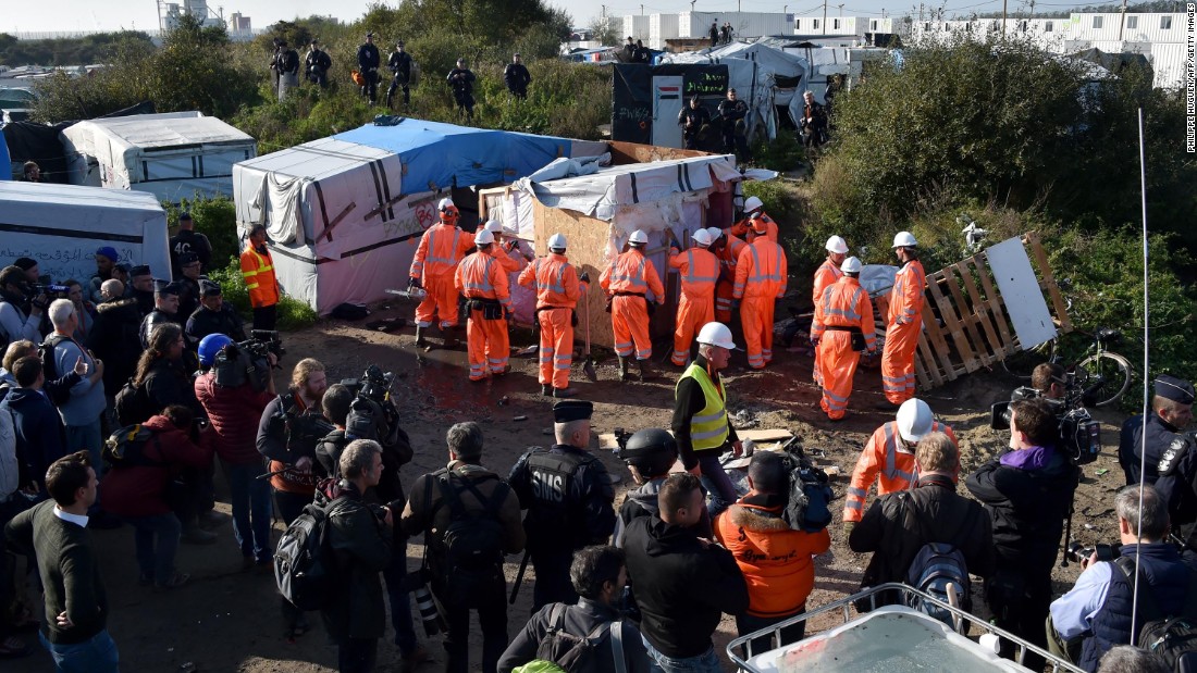 Workers begin demolishing shelters in the camp on October 25.