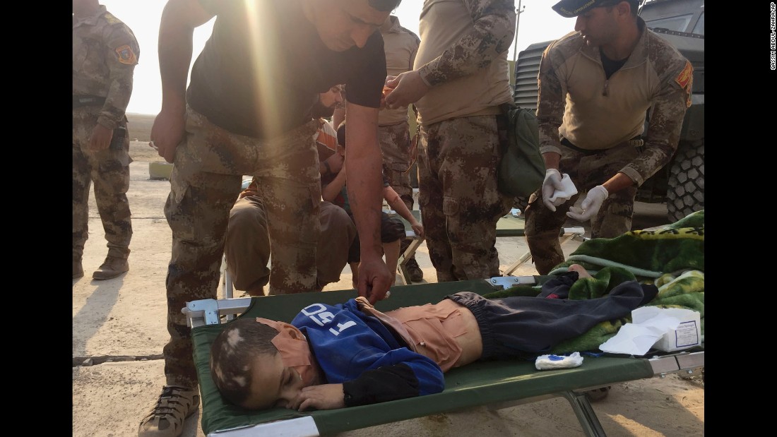 Soldiers give first aid to an injured boy in Tob Zawa on October 25. 