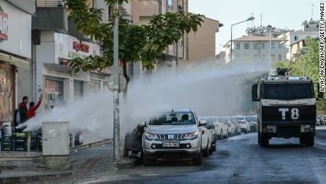 Turkish anti-riot police use a water cannon to disperse protesters on October 26, during a demonstration against the detention of the Kurdish-majority city&#39;s co-mayors in Diyarbakir.