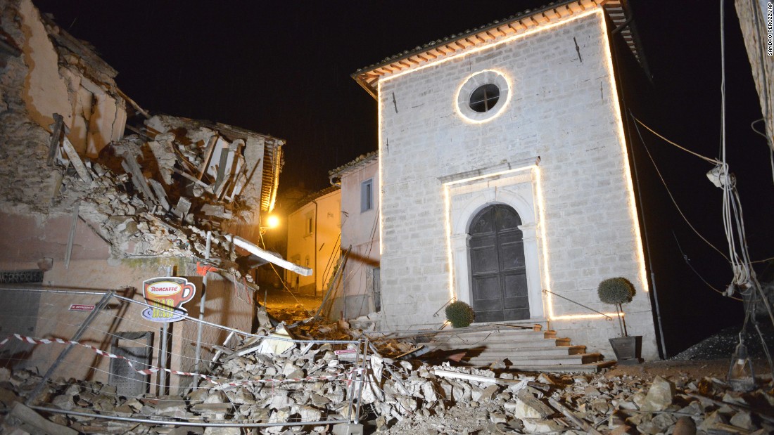 The Church of San Sebastiano stands amid damaged houses in Castelsantangelo sul Nera on October 26.