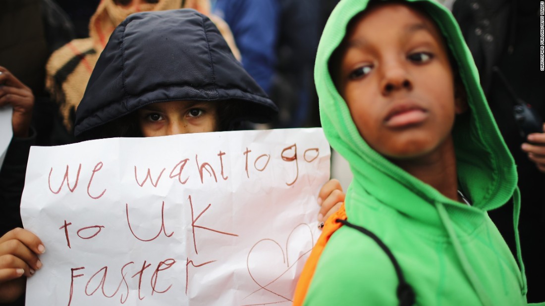 Women and children protest their case to the UK government from the Jungle, as authorities continue the destruction of the camp on October 26.