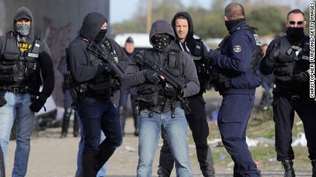French police clear the main entrance and road into the Calais &#39;Jungle&#39; migrant camp.