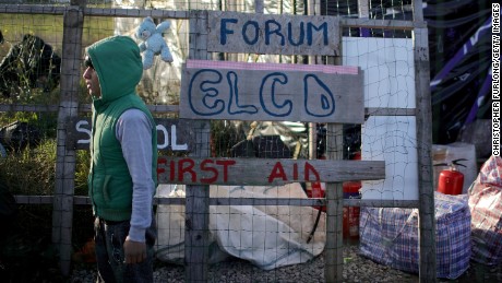 A young migrant stands outside the Calais camp school house on Friday. 