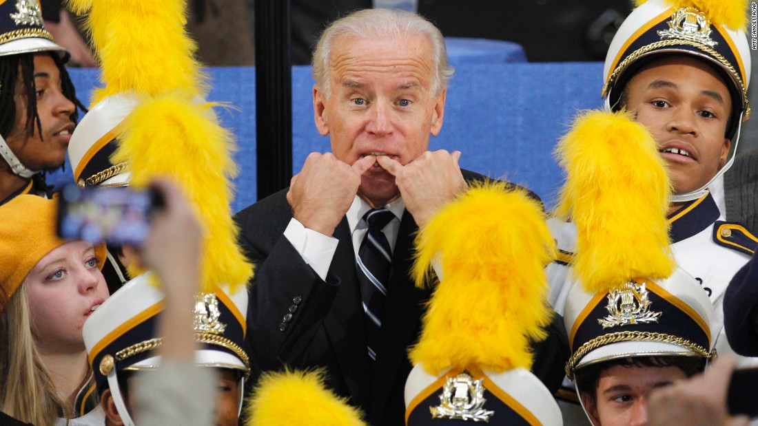 Biden whistles to get someone&#39;s attention as he stands with a high school marching band in Euclid, Ohio, in November 2011.