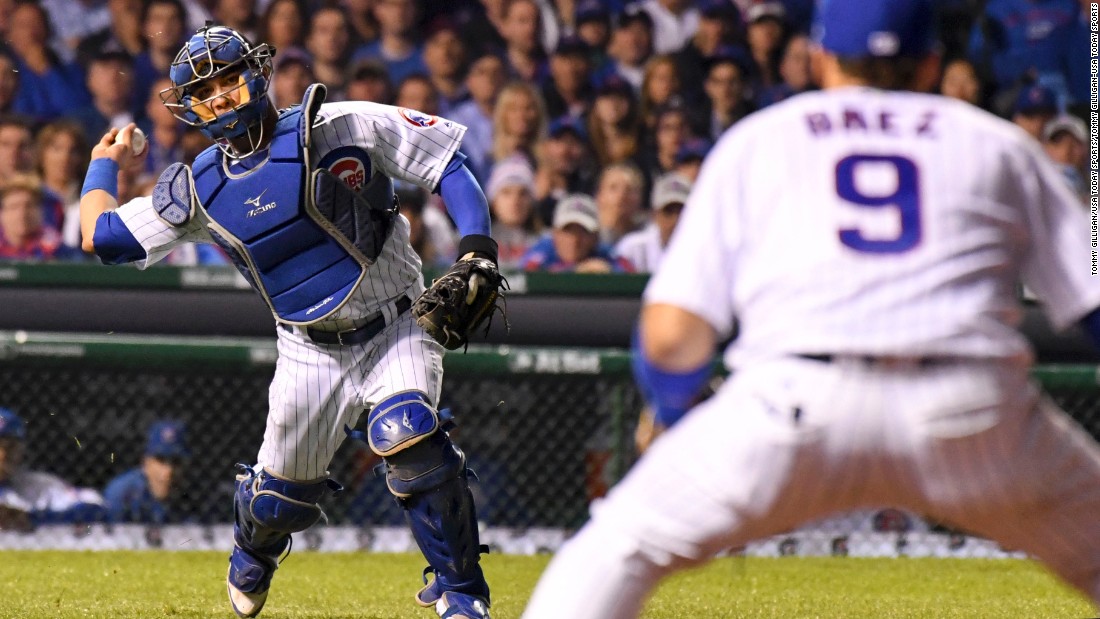 Willson Contreras of the Cubs throws to second baseman Javier Baez for an out on a bunt attempt by Indians starting pitcher Josh Tomlin in Game 3.