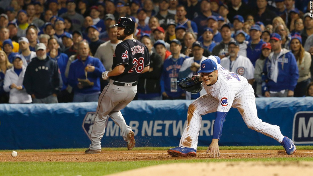 Cleveland&#39;s Corey Kluber is safe at first as Cubs first baseman Anthony Rizzo can&#39;t make a play on a wild throw by third baseman Kris Bryant during the second inning of Game 4.