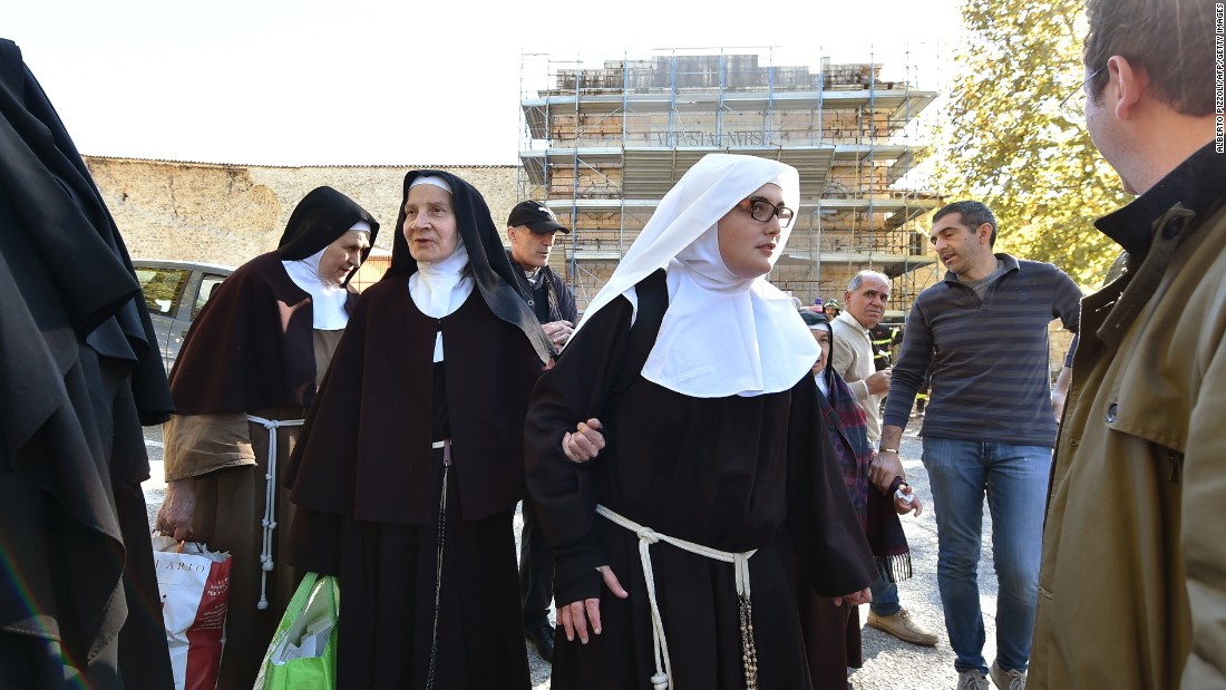 A group of nuns leave the center of Norcia on October 30 after being rescued earlier. Residents ran onto the streets in a panic when the quake struck in the  morning.