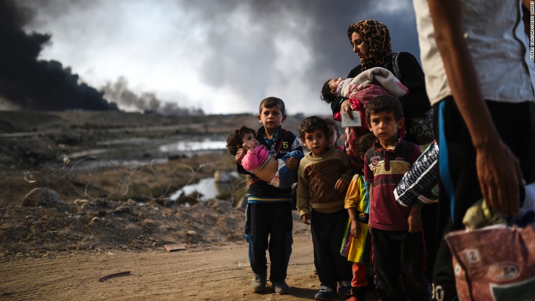 Displaced families are seen on the road near Qayyara on Saturday, October 29.