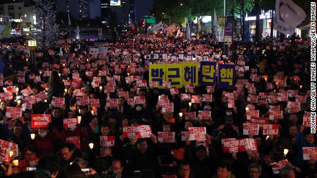 SEOUL, SOUTH KOREA - OCTOBER 29:  Thousands of South Koreans took to the streets in the city center to demand President Park Geun-hye to step down on October 29, 2016 in Seoul, South Korea. The protest stems from allegations that President Park let her friend Choi Soon-Sil interfere in important state affairs. (Photo by Woohae Cho/Getty Images)