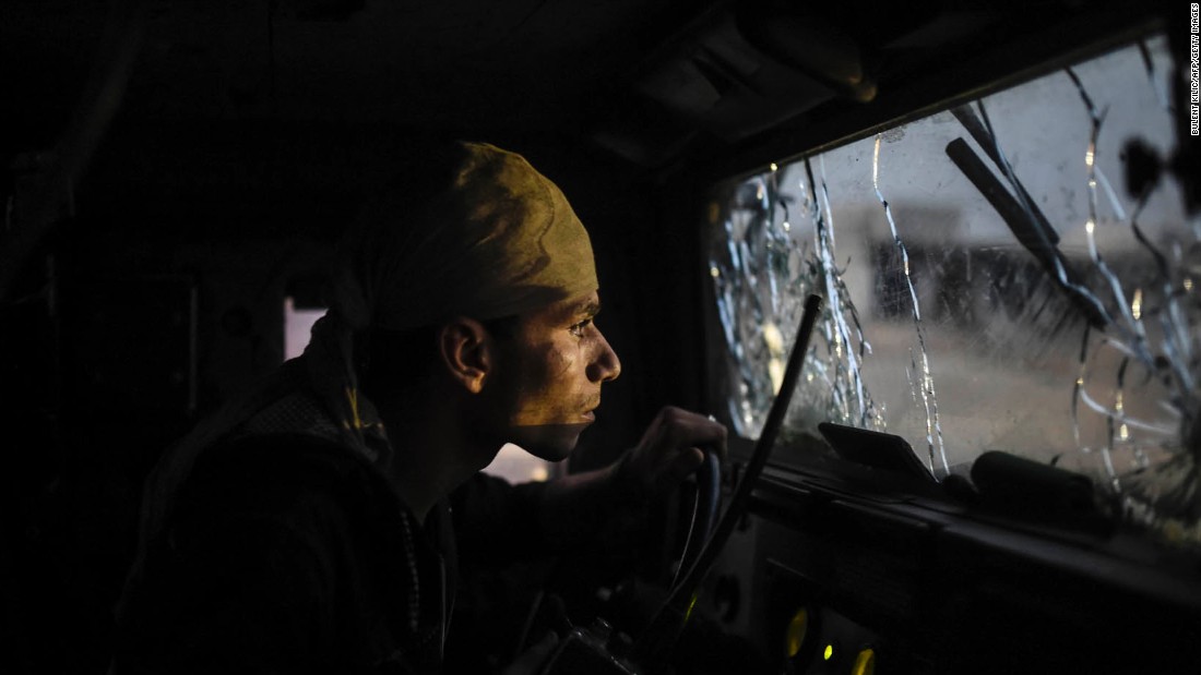 An Iraqi soldier navigates through a shattered windshield as coalition forces advance on Bazwaya on October 31.