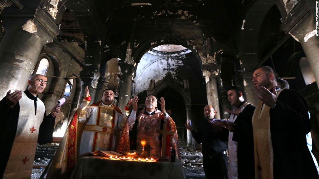 Archbishop Yohanna Petros Mouche, center, performs Mass in the liberated town of Qaraqosh on Sunday, October 30.