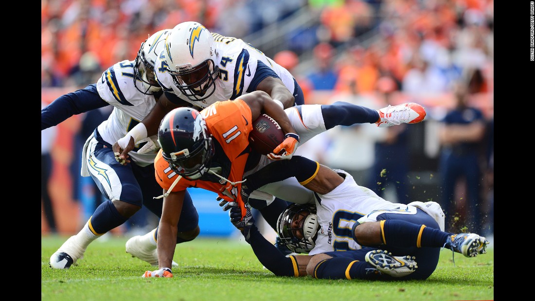 Denver wide receiver Jordan Norwood is dragged down by San Diego safety Dwight Lowery during an NFL game in Denver on Sunday, October 30.