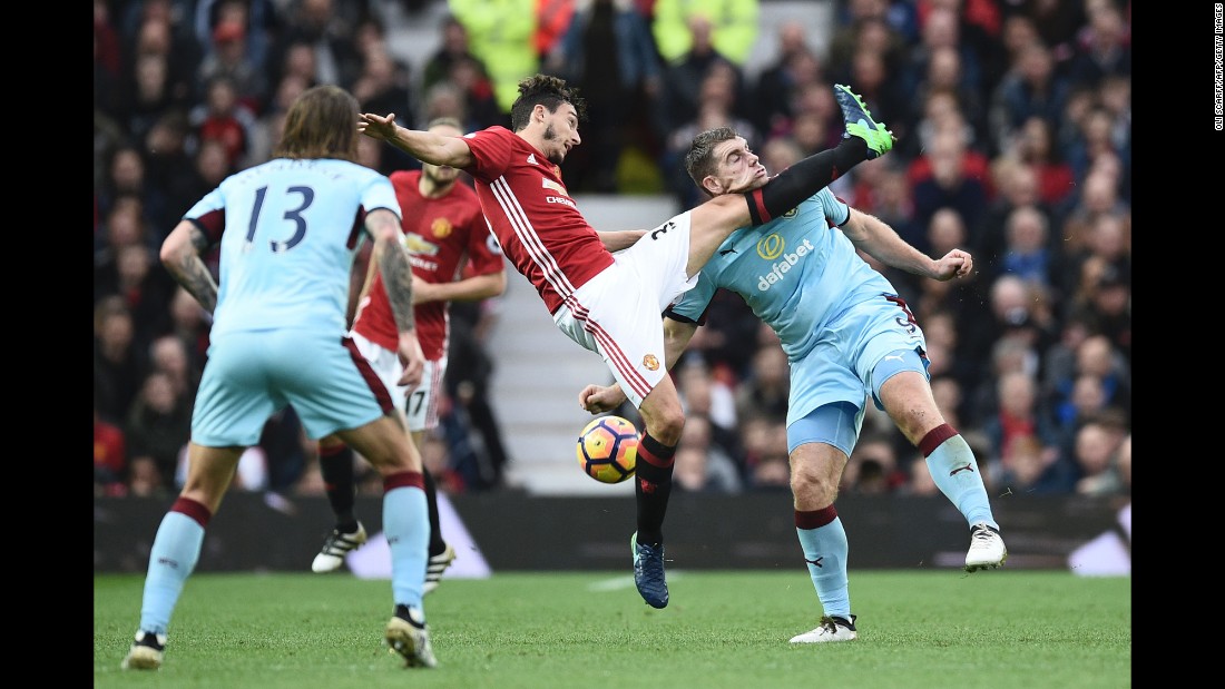 The leg of Manchester United defender Matteo Darmian catches the chin of Burnley forward Sam Vokes during a Premier League match in Manchester, England, on Saturday, October 29.