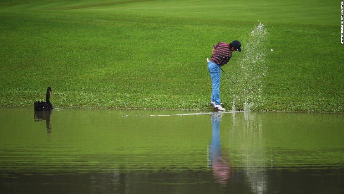 Xiong Zong hits his ball out of the water during a pro-am event in Shanghai, China, on Wednesday, October 26.