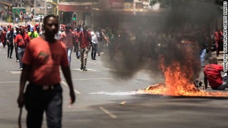 Garbage burns in the road during a demonstration Wednesday in Pretoria, South Africa.