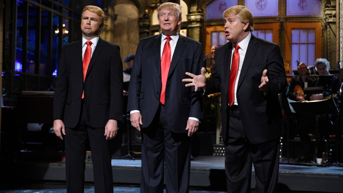 Trump is flanked by impersonators Taran Killam, left, and Darrell Hammond during his &quot;Saturday Night Live&quot; monologue on November 7, 2015.