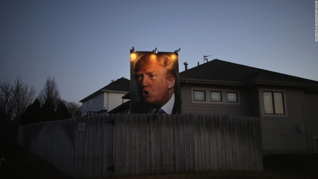 A giant Trump poster is illuminated outside a home in Des Moines, Iowa, on January 28, 2016.